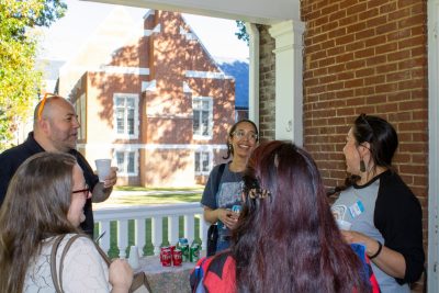 A group of +Policy Network meet and greet attendees conversating and laughing.