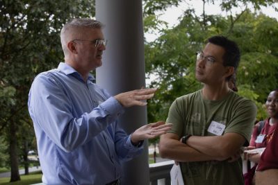 (From left) Professor of Urban Affairs and Planning Ralph Hall talks with new faculty member Le Wang, Professor of Agricultural and Applied Economics, at the 2023 +Policy Network mixer. Photo by Cassidy Schultz.