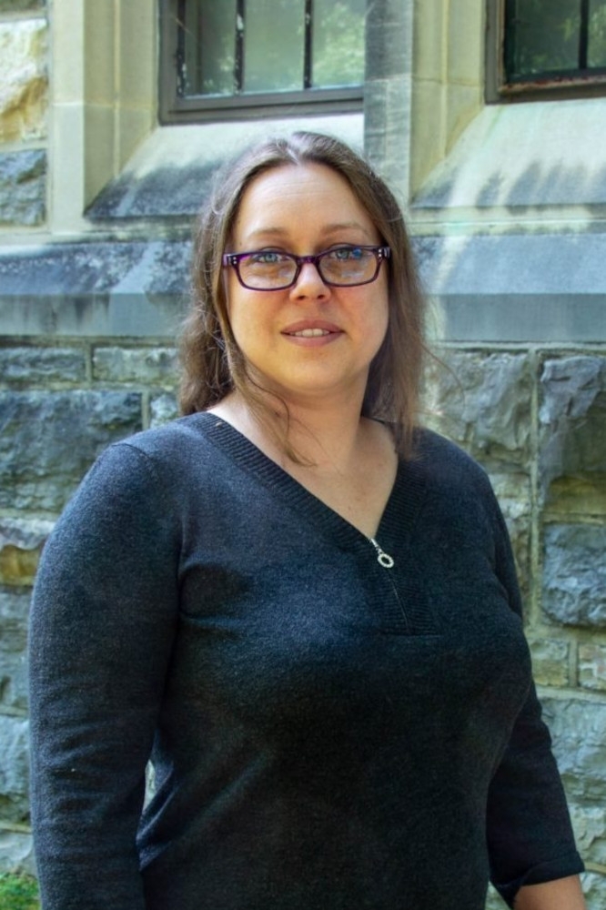  Anne-Lise Velez Headshot in front of stone building